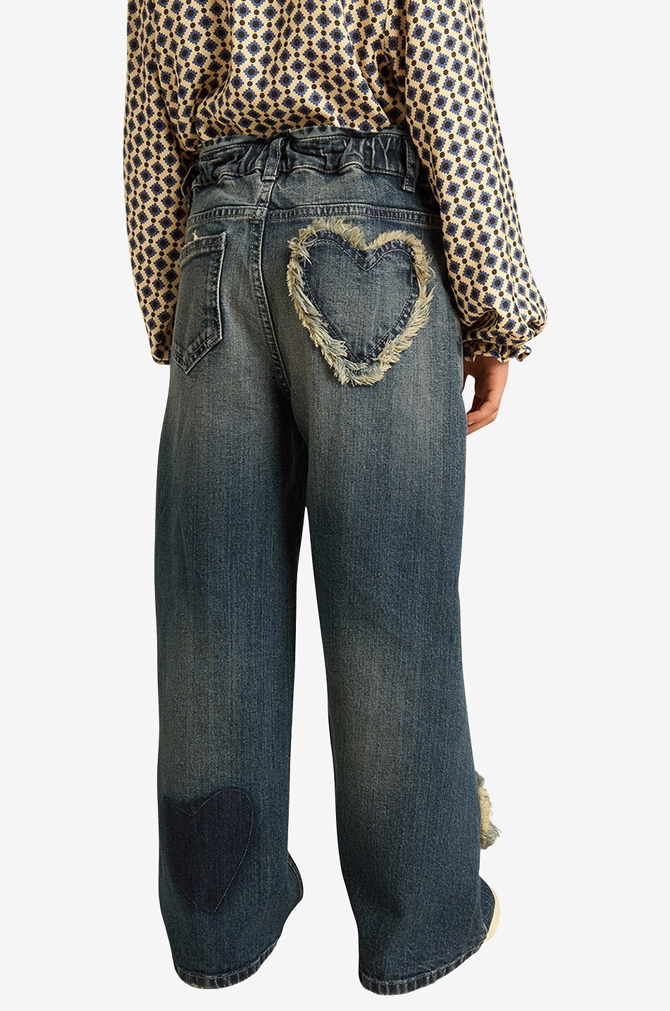 Heart patch adorned girl's faded wide-leg jeans